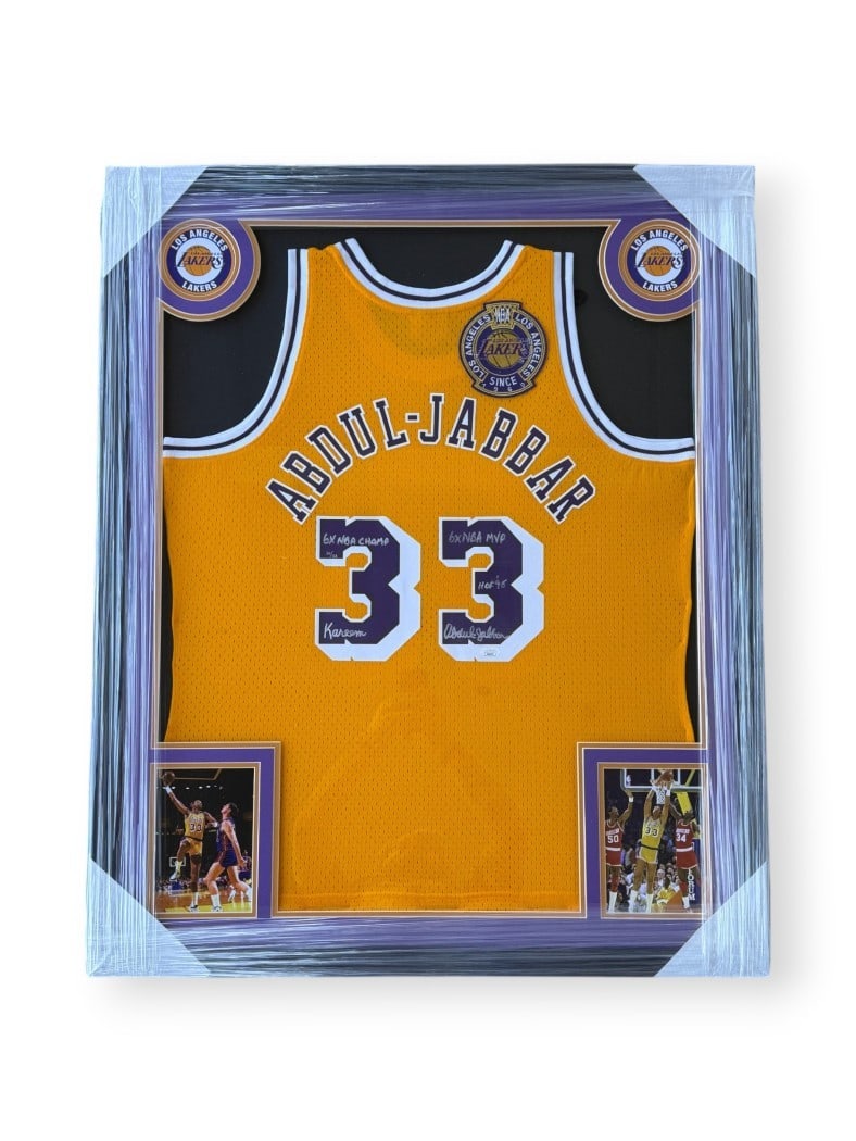 Framed Lakers jersey signed by Kareem Abdul-Jabbar JSA authenticated: Framed Lakers jersey signed by Kareem Abdul-Jabbar JSA authenticated This framed Los Angeles Lakers jersey is autographed by Kareem Abdul-Jabbar and features the inscription "6x NBA Champ." The piece 