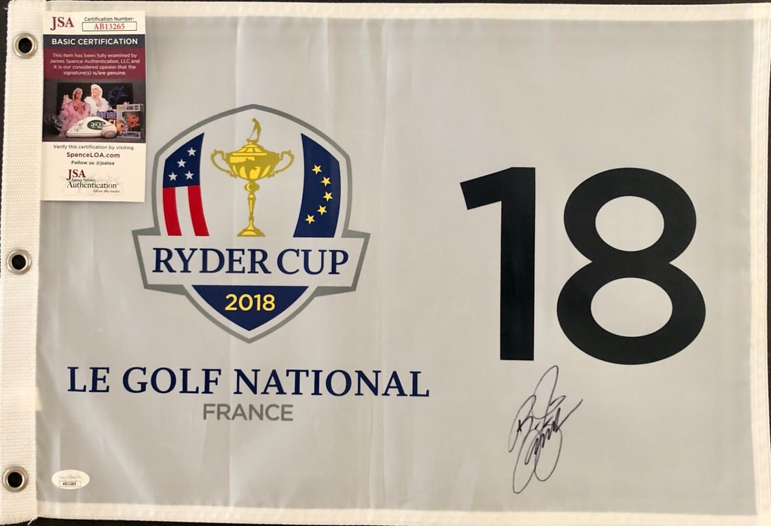 Rickie Fowler Signed 2018 Ryder Cup Flag JSA Authenticated: Rickie Fowler Signed 2018 Ryder Cup Flag JSA Authenticated This is an official 2018 Ryder Cup pin flag from Le Golf National in France, beautifully signed by professional golfer Rickie Fowler. The aut