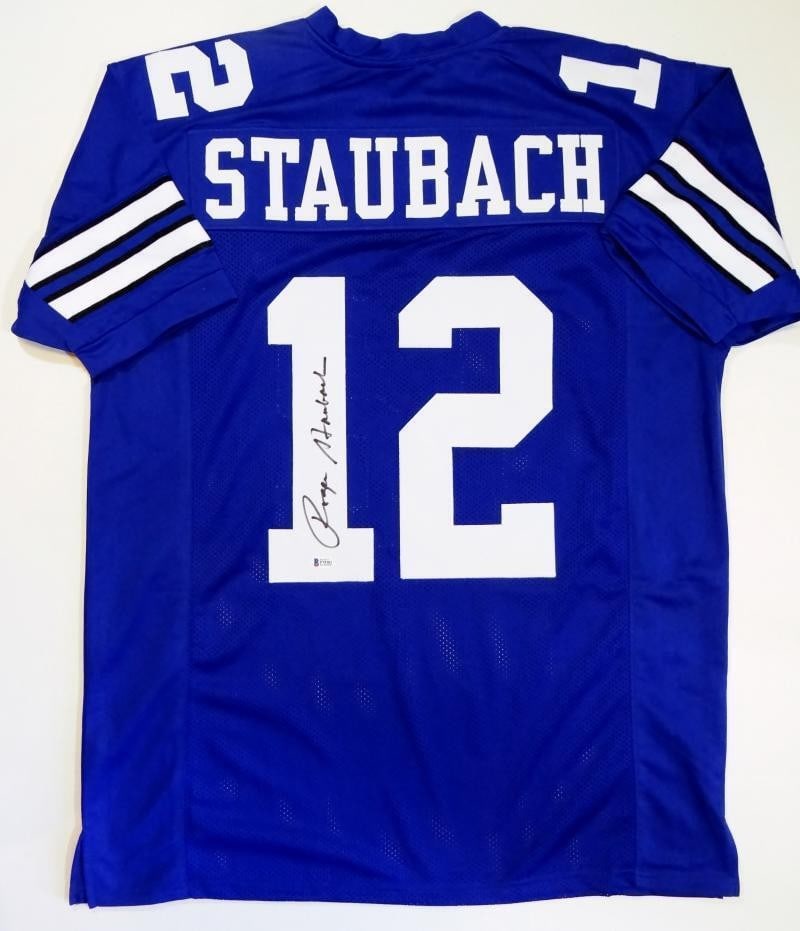 Signed Dallas Cowboys Blue Jersey Roger Staubach Beckett Authenticated: Signed Dallas Cowboys Blue Jersey Roger Staubach Beckett Authenticated This is a blue pro style jersey autographed by Roger Staubach. The jersey features an authenticated signature, verified by Becket