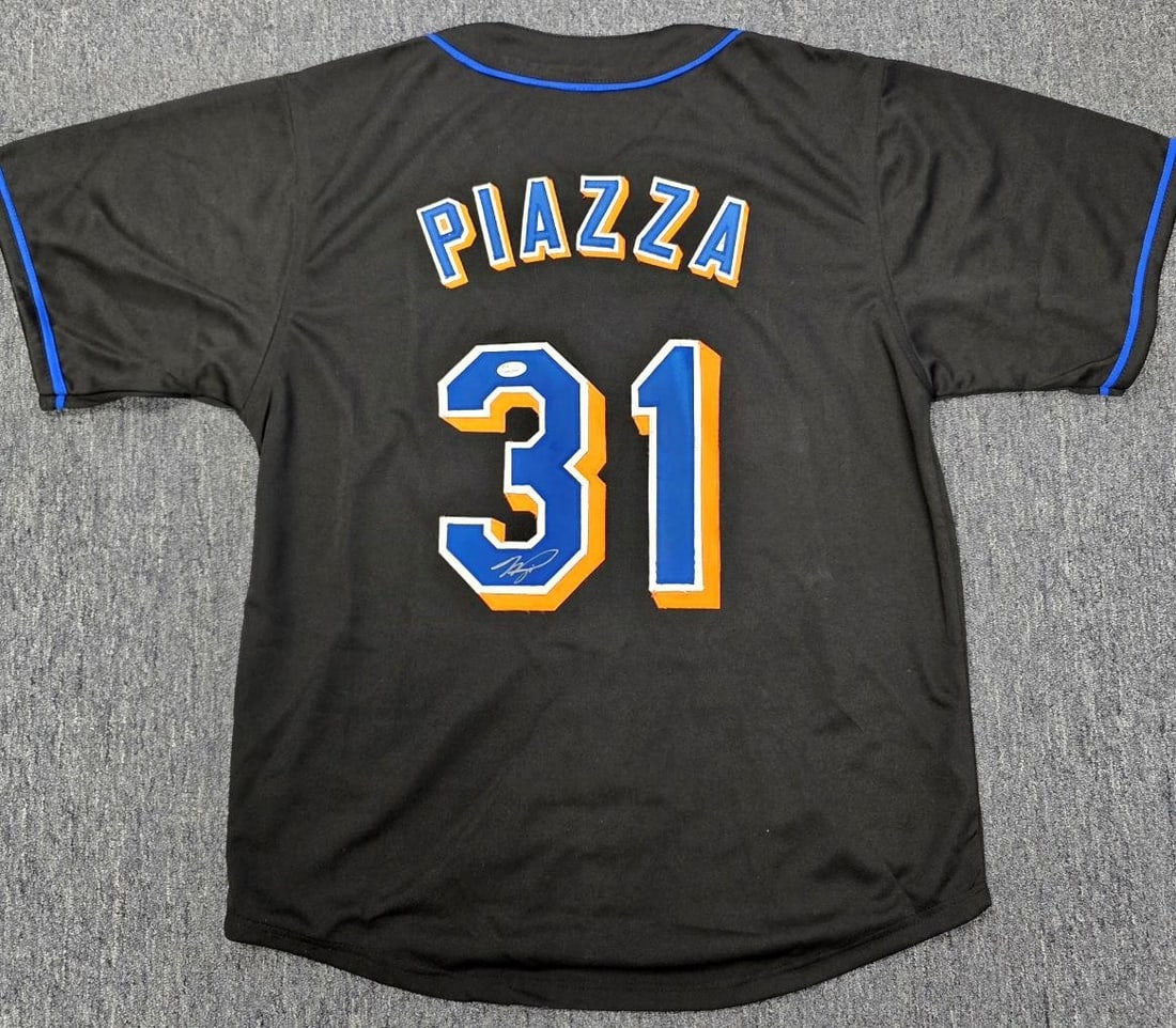 Autographed New York Mets Jersey Signed by Mike Piazza JSA Authenticated: Autographed New York Mets Jersey Signed by Mike Piazza JSA Authenticated This New York Mets jersey features the autograph of Mike Piazza and is authenticated by James Spence Authentication (JSA). It i