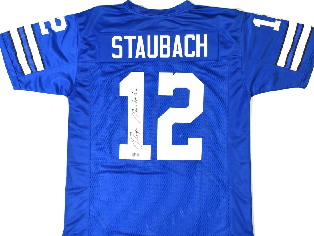 Roger Staubach Signed Dallas Cowboys Blue Jersey With Beckett W Hologram: Roger Staubach Signed Dallas Cowboys Blue Jersey With Beckett W Hologram This blue pro style jersey is autographed by Roger Staubach and features a Beckett W hologram for added authenticity. Represent