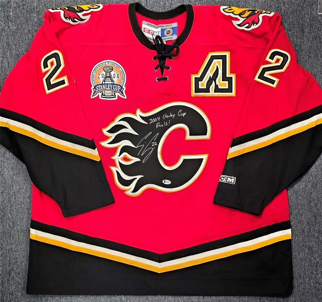 Calgary Flames Hockey Jersey Signed by Craig Conroy with 2004 Finals Inscription BAS: Calgary Flames Hockey Jersey Signed by Craig Conroy with 2004 Finals Inscription BAS This authentic CCM Calgary Flames jersey is signed by Craig Conroy and commemorates the 2004 Finals. The autograph 
