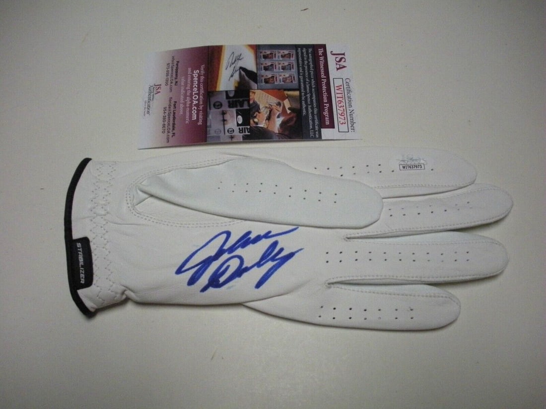 Signed John Daly Golf Glove With JSA COA Featuring Cigarette Detail: Signed John Daly Golf Glove With JSA COA Featuring Cigarette Detail This is an original golf glove signed by legendary golfer John Daly. The glove is a collectible item representing Daly, known for hi