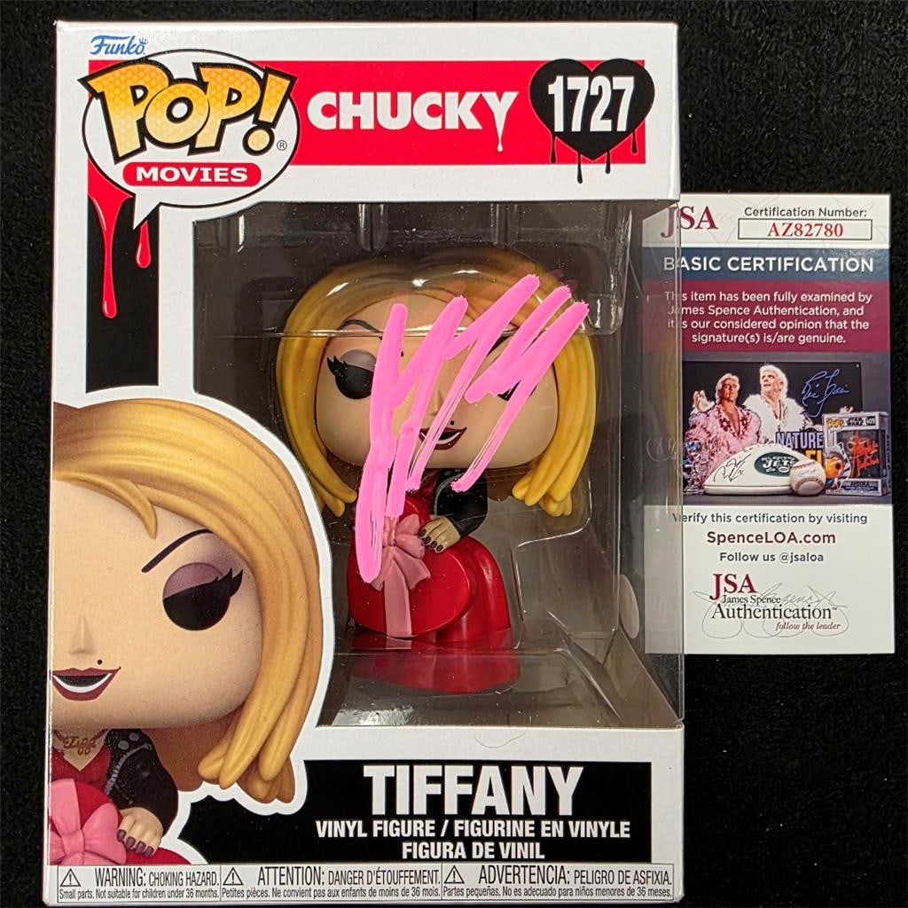 Jennifer Tilly Autographed Tiffany Funko Pop 1727 Pink Signature JSA Authenticated: Jennifer Tilly Autographed Tiffany Funko Pop 1727 Pink Signature JSA Authenticated This original Chucky Tiffany Funko Pop! #1727 features a pink autograph signed by Jennifer Tilly. The autograph is au