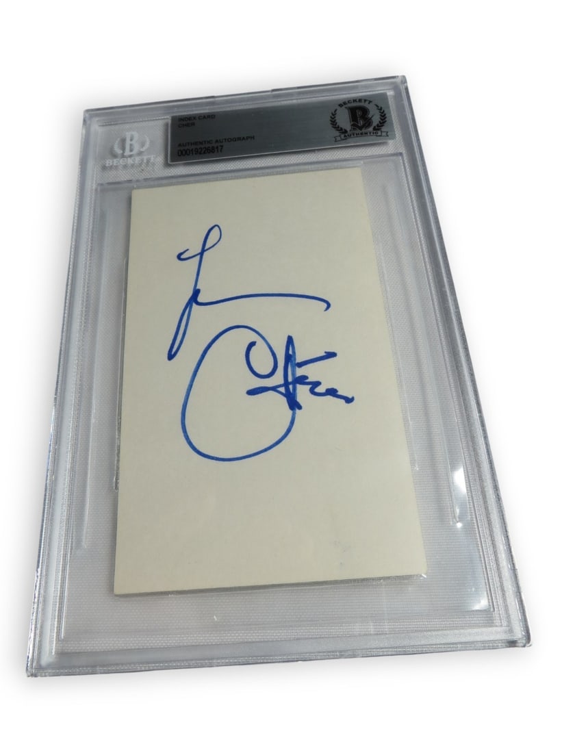 Autographed Cher Index Card Beckett Authenticated BAS Encapsulated: Autographed Cher Index Card Beckett Authenticated BAS Encapsulated This autographed index card features the signature of Cher, the renowned singer and actress. The autograph has been professionally au