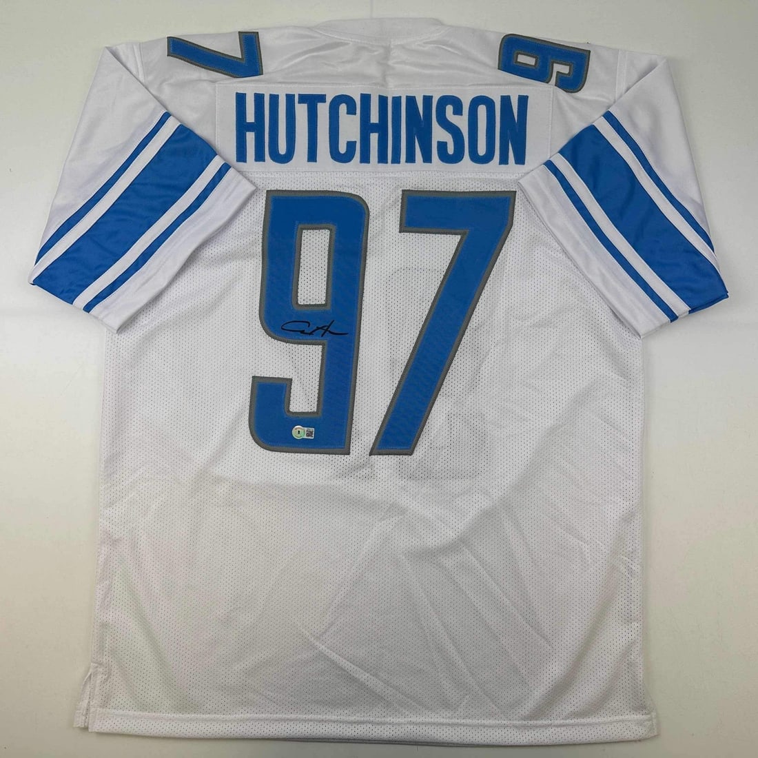 Aidan Hutchinson Signed Custom Detroit White Football Jersey Beckett Authenticated: Aidan Hutchinson Signed Custom Detroit White Football Jersey Beckett Authenticated This is a custom Detroit Lions white football jersey autographed by Aidan Hutchinson. The jersey displays the player'