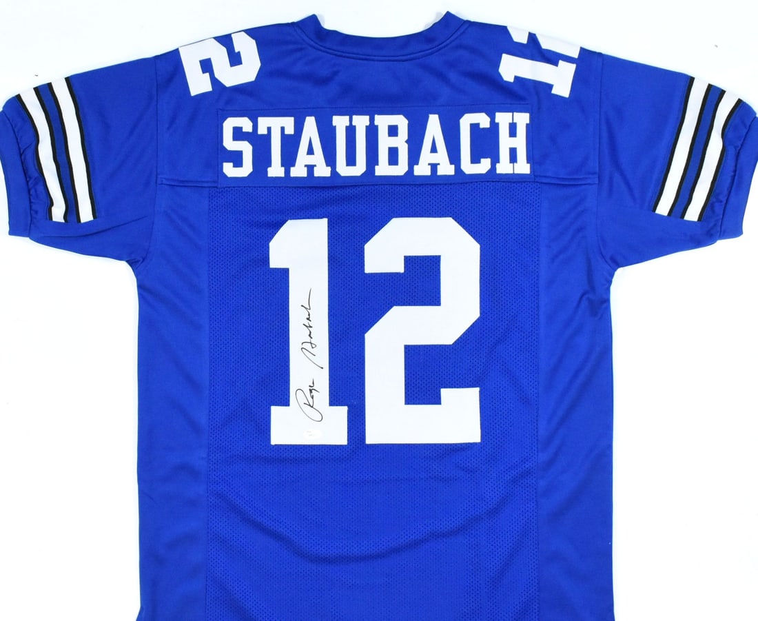 Signed Dallas Cowboys Blue Jersey by Roger Staubach with JSA Authentication: Signed Dallas Cowboys Blue Jersey by Roger Staubach with JSA Authentication This blue pro style jersey is autographed by Roger Staubach and represents the Dallas Cowboys. The jersey is an original ite