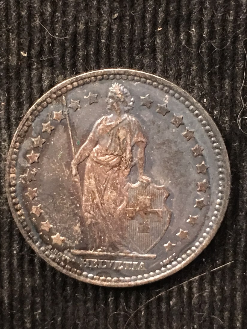 1876 Toned Silver Switzerland Franc Coin CH UNC Uncertified: 1876 Toned Silver Switzerland Franc Coin CH UNC Uncertified This 1876 Silver Switzerland Franc is a beautifully toned coin in CH UNC condition. It showcases the intricate designs typical of Swiss curr