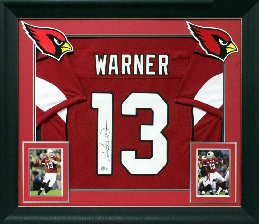 Framed Arizona Cardinals Jersey Signed by Kurt Warner Beckett BAS Witnessed: Framed Arizona Cardinals Jersey Signed by Kurt Warner Beckett BAS Witnessed This professionally framed red Pro Style jersey features the authentic signature of Kurt Warner from the Arizona Cardinals. 
