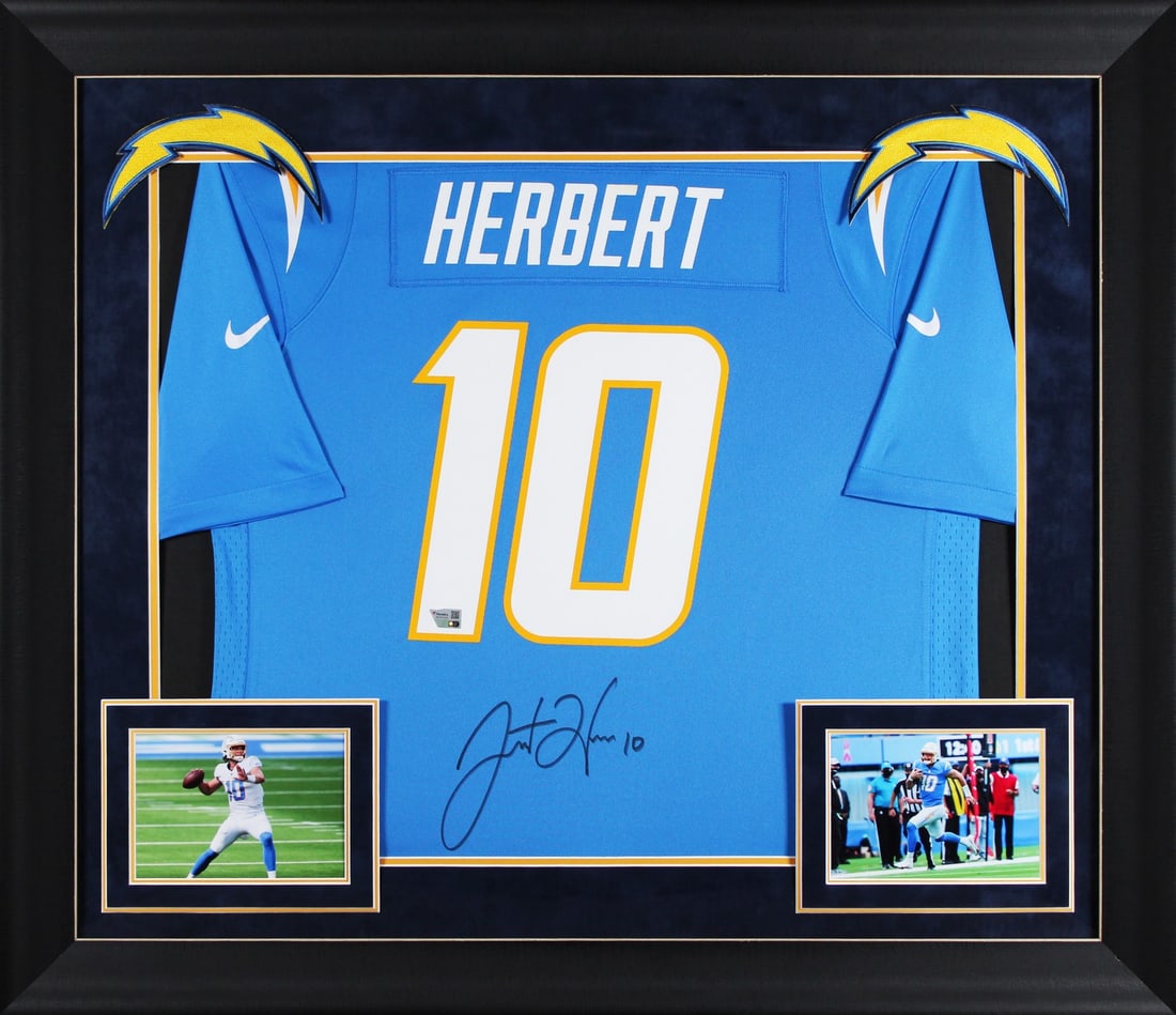Framed Justin Herbert Autographed Powder Blue Jersey With Fanatics Authentication: Framed Justin Herbert Autographed Powder Blue Jersey With Fanatics Authentication This professionally framed powder blue Nike Game jersey has been personally signed by Justin Herbert of the Los Angele