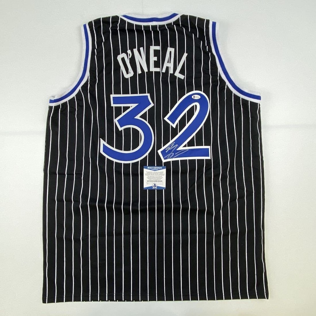 Shaquille O'Neal Signed Custom Orlando Pinstripe Jersey Beckett Authenticated: Shaquille O'Neal Signed Custom Orlando Pinstripe Jersey Beckett Authenticated This is a custom black pinstripe jersey featuring the name, number, and authenticated signature of NBA basketball star Sha