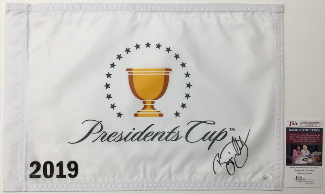 Bryson DeChambeau Signed The Presidents Cup 2019 Pin Flag JSA AZ58935: Bryson DeChambeau Signed The Presidents Cup 2019 Pin Flag JSA AZ58935 Official The President's Cup 2019 pin flag signed by PGA star Bryson DeChambeau. This original piece features a perfect signature 