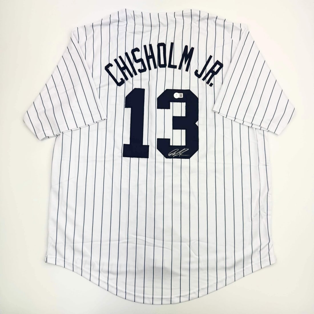 Custom Pinstripe Jersey Signed by Jazz Chisholm Jr with Beckett Authentication: Custom Pinstripe Jersey Signed by Jazz Chisholm Jr with Beckett Authentication This is a custom New York pinstripe baseball jersey autographed by Jazz Chisholm Jr. The jersey is intended as a collecti