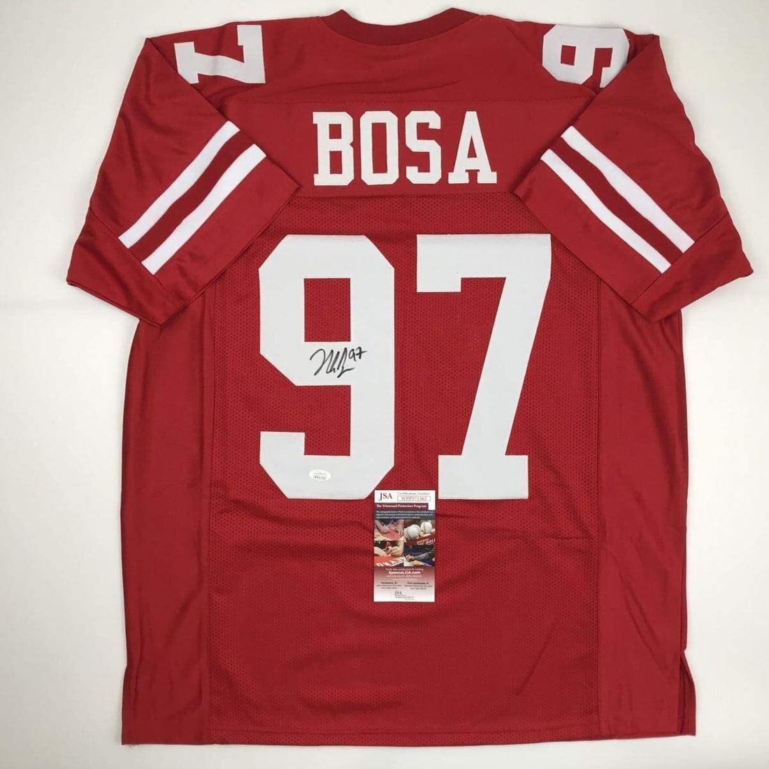 Nick Bosa Signed Custom Red Football Jersey JSA Authenticated: Nick Bosa Signed Custom Red Football Jersey JSA Authenticated This autographed Nick Bosa red football jersey is a custom piece designed as a collectible item. It features the name, number, and authent