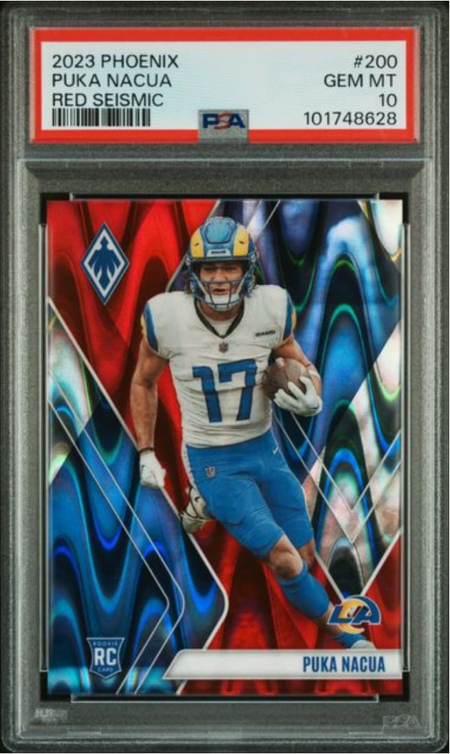 2023 Panini Phoenix Puka Nacua Rookie #200 Red Seismic /199 PSA 10: 2023 Panini Phoenix Puka Nacua Rookie #200 Red Seismic /199 PSA 10 This is a graded 2023 Panini Phoenix Puka Nacua #200 Red Seismic rookie card, limited to just 199 copies. The card has been evaluated