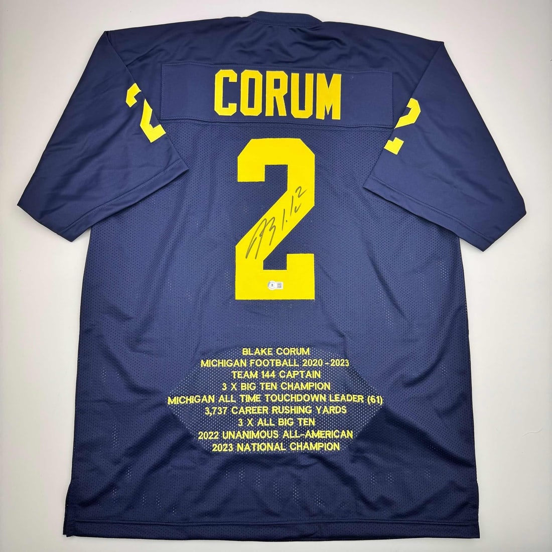 Blake Corum Signed Custom Michigan College Jersey Beckett Authenticated: Blake Corum Signed Custom Michigan College Jersey Beckett Authenticated This is a custom Michigan Wolverines blue stat college jersey autographed by Blake Corum. The jersey is intended as a collectibl