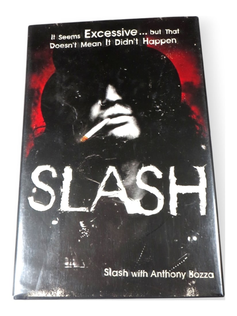 First Edition Slash Signed Book with JSA Authentication: First Edition Slash Signed Book with JSA Authentication This is an original hardcover book signed by Slash, the renowned guitarist from Guns N' Roses. The autograph is authenticated by James Spence Au