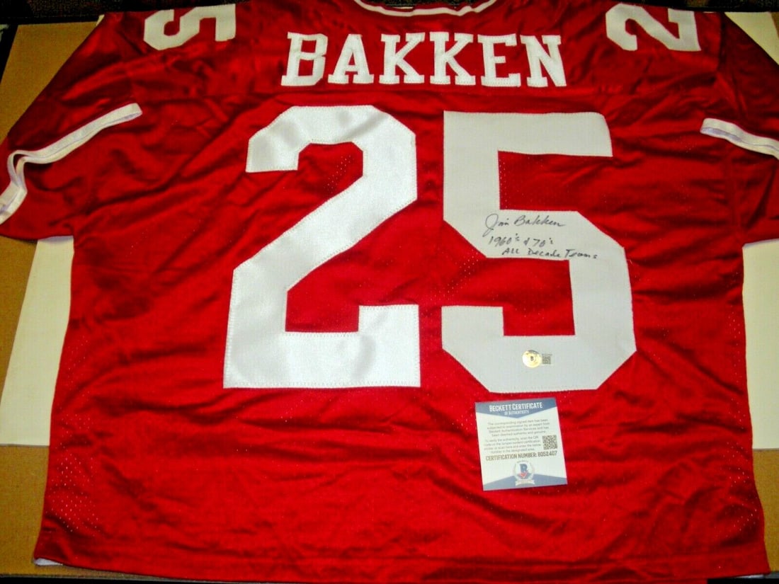 Champion Jersey Signed by Jim Bakken with Beckett COA Wisconsin Badgers Football: Champion Jersey Signed by Jim Bakken with Beckett COA Wisconsin Badgers Football This is an official licensed Champion jersey signed by Jim Bakken, representing the Wisconsin Badgers. The jersey inclu