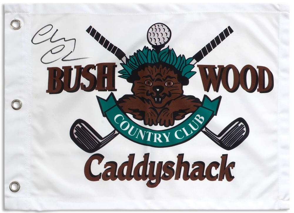 Chevy Chase Signed Caddyshack 18x13 Golf Flag with COA: Chevy Chase Signed Caddyshack 18x13 Golf Flag with COA Celebrate a classic comedy with this original Chevy Chase signed Caddyshack Bushwood golf flag, measuring 18x13 inches. Featuring the iconic Cadd