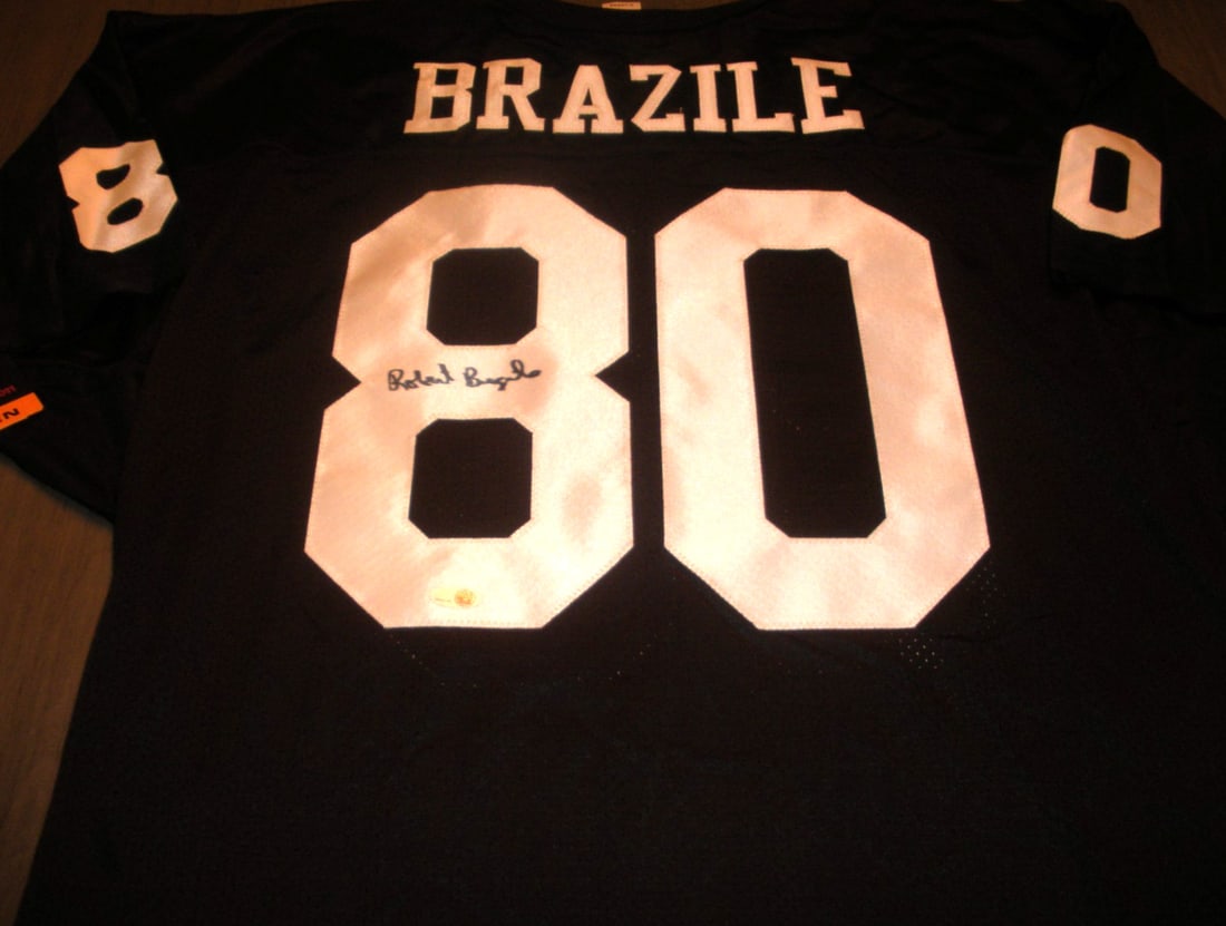 Robert Brazile Signed Jackson State Official Wilson Jersey JSA COA Rare: Robert Brazile Signed Jackson State Official Wilson Jersey JSA COA Rare Elevate your collection with this rare Jackson State jersey signed by Robert Brazile. This officially licensed Wilson jersey is 