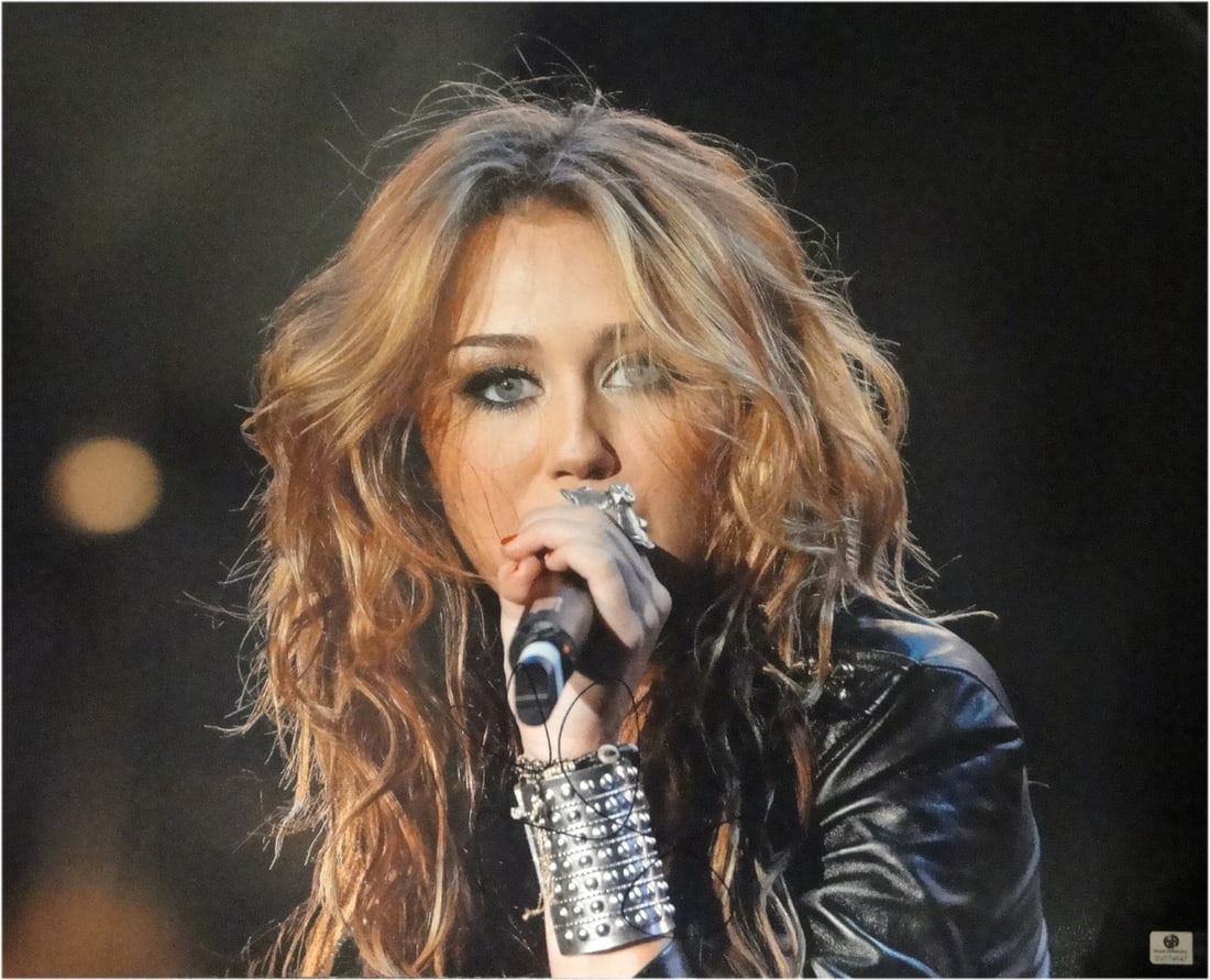 16x20 Photograph of Miley Cyrus Signed with Global Authentics COA: 16x20 Photograph of Miley Cyrus Signed with Global Authentics COA This 16x20 photograph features Miley Cyrus performing with a microphone and is personally hand-signed by her. The autograph is authent