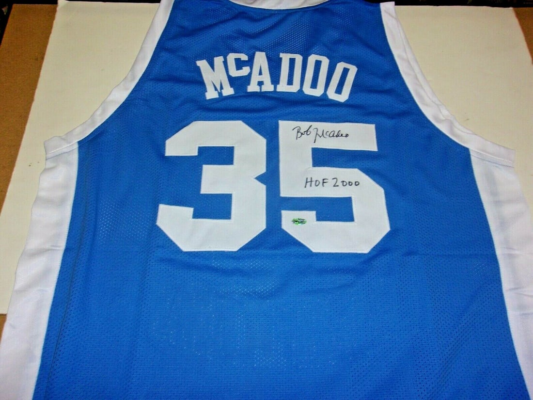 Bob McAdoo Signed North Carolina Tar Heels Jersey with COA: Bob McAdoo Signed North Carolina Tar Heels Jersey with COA This is an original pre-owned jersey signed by Bob McAdoo, a Hall of Famer from the North Carolina Tar Heels. It features a striking blue col