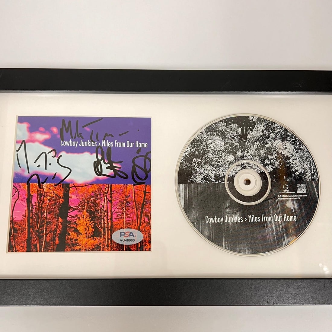 Cowboy Junkies Signed Framed Miles From Our Home Album PSA/DNA: Cowboy Junkies Signed Framed Miles From Our Home Album PSA/DNA This listing features a framed album cover of "Miles From Our Home" by Cowboy Junkies, signed by the band members. The autograph has been
