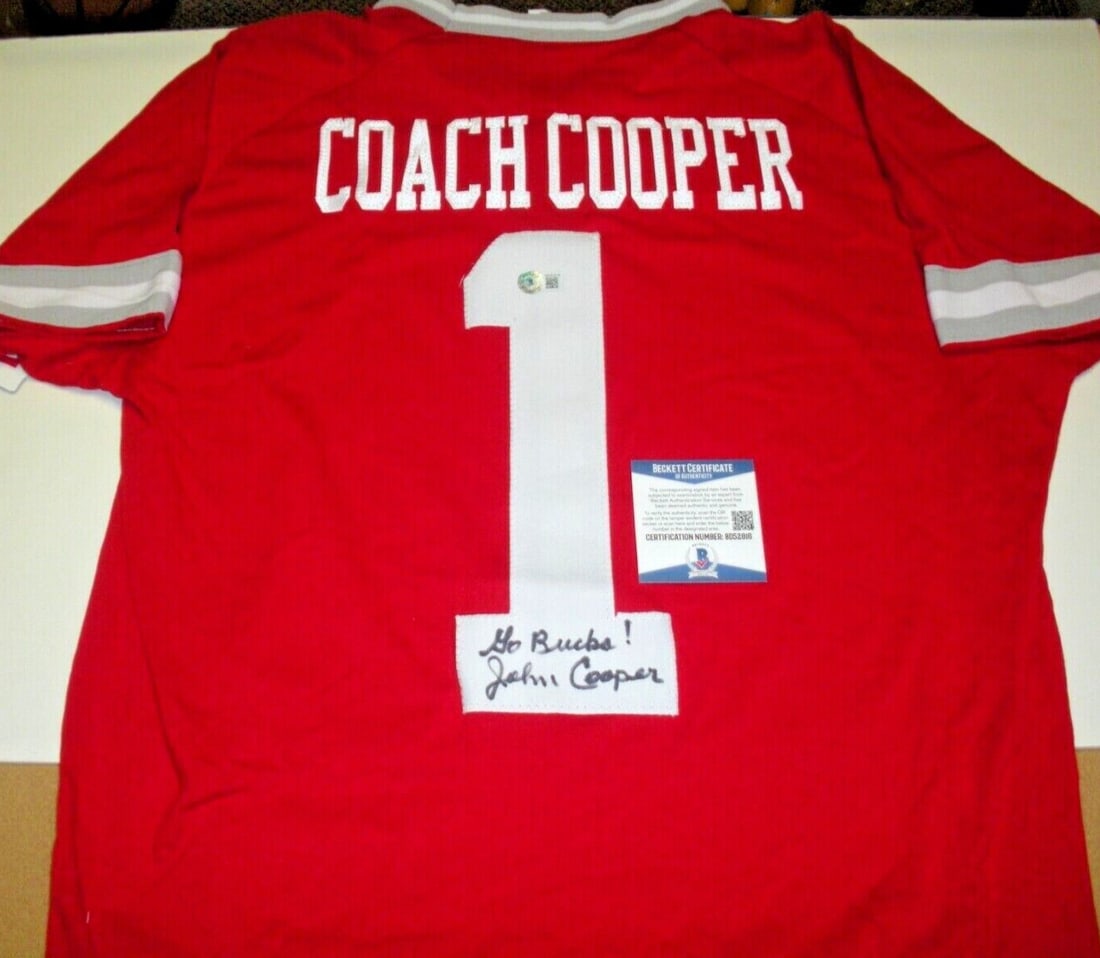John Cooper Signed Official Wilson Ohio State Buckeyes Jersey: John Cooper Signed Official Wilson Ohio State Buckeyes Jersey This official licensed Wilson jersey, signed by John Cooper, is a must-have for any Ohio State Buckeyes fan. It features a collectible aut