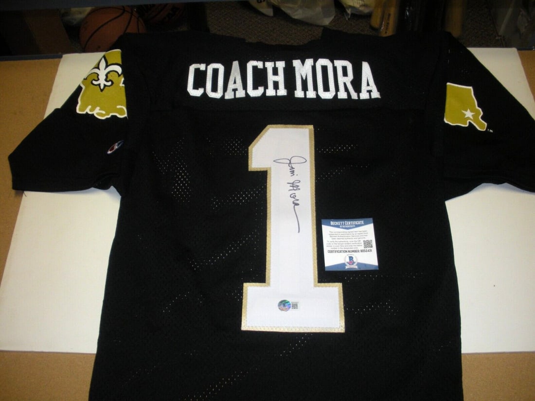 Jim Mora Autographed New Orleans Saints Champion Jersey with Beckett COA: Jim Mora Autographed New Orleans Saints Champion Jersey with Beckett COA This pre-owned official licensed Champion jersey is signed by Jim Mora of the New Orleans Saints. It is an original NFL footbal