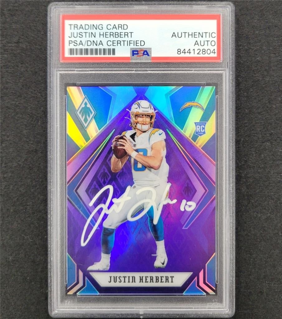 Justin Herbert 2020 Panini Phoenix Purple Refractor Auto /149 PSA NFL Rookie Card: Justin Herbert 2020 Panini Phoenix Purple Refractor Auto /149 PSA NFL Rookie Card This is a 2020 Panini Phoenix Purple Refractor #103 sports trading card featuring Justin Herbert, an autographed rooki