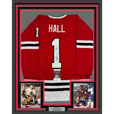 Glenn Hall signed Chicago Blackhawks jersey framed 35x39 with JSA COA: Glenn Hall signed Chicago Blackhawks jersey framed 35x39 with JSA COA This professionally framed and matted Chicago Red hockey jersey is autographed by Glenn Hall. The display includes two 5x7 photos 