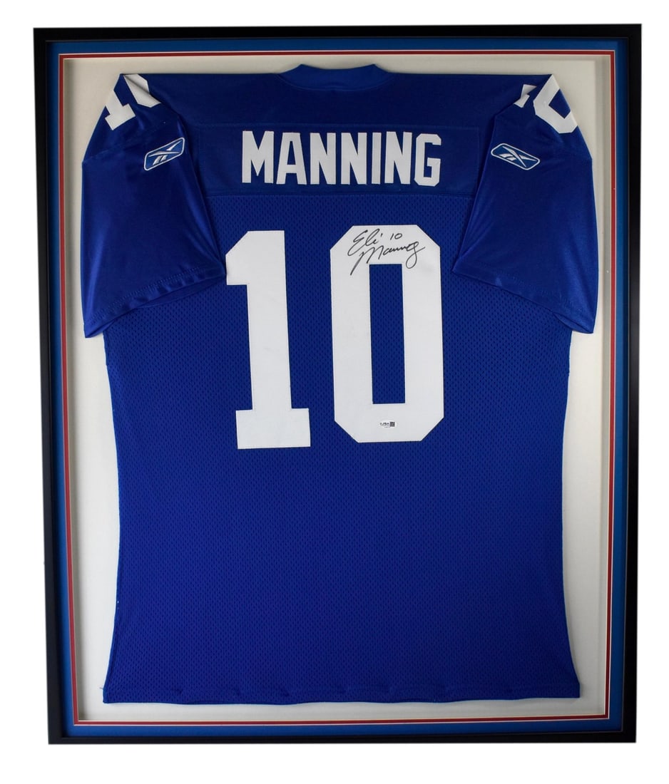 Framed Eli Manning Signed New York Giants Jersey With JSA Authentication: Framed Eli Manning Signed New York Giants Jersey With JSA Authentication This framed display features a New York Giants jersey autographed by Eli Manning. The jersey is professionally mounted in a pre