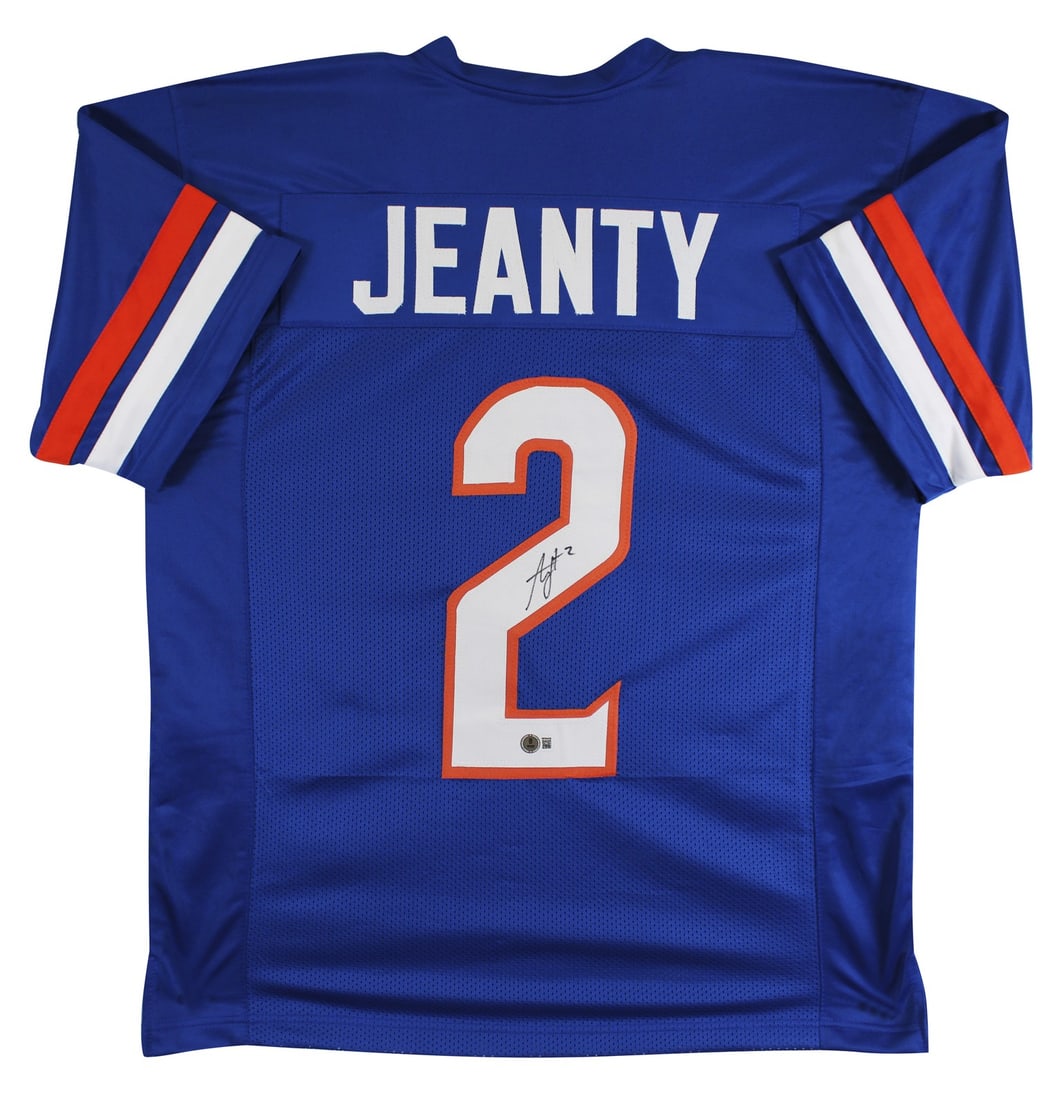 Ashton Jeanty Signed Blue Football Jersey Beckett BAS Witness Boise State: Ashton Jeanty Signed Blue Football Jersey Beckett BAS Witness Boise State This blue pro style jersey has been personally signed by Ashton Jeanty of the Boise State Broncos. The autograph is authentica