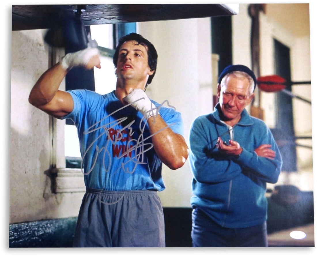 Sylvester Stallone Autographed 16X20 Rocky Speedbag Photo JSA Certified: Sylvester Stallone Autographed 16X20 Rocky Speedbag Photo JSA Certified This stunning 16X20 photograph features Sylvester Stallone, renowned for his iconic role as Rocky Balboa. The photo is autograph