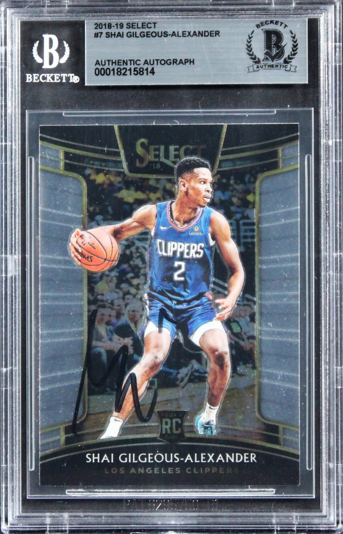 Shai Gilgeous-Alexander Autographed 2018 Rookie Card Beckett Authenticated Slab: Shai Gilgeous-Alexander Autographed 2018 Rookie Card Beckett Authenticated Slab This is an original 2018 Select #7 rookie card featuring Shai Gilgeous-Alexander of the Los Angeles Clippers. The card h