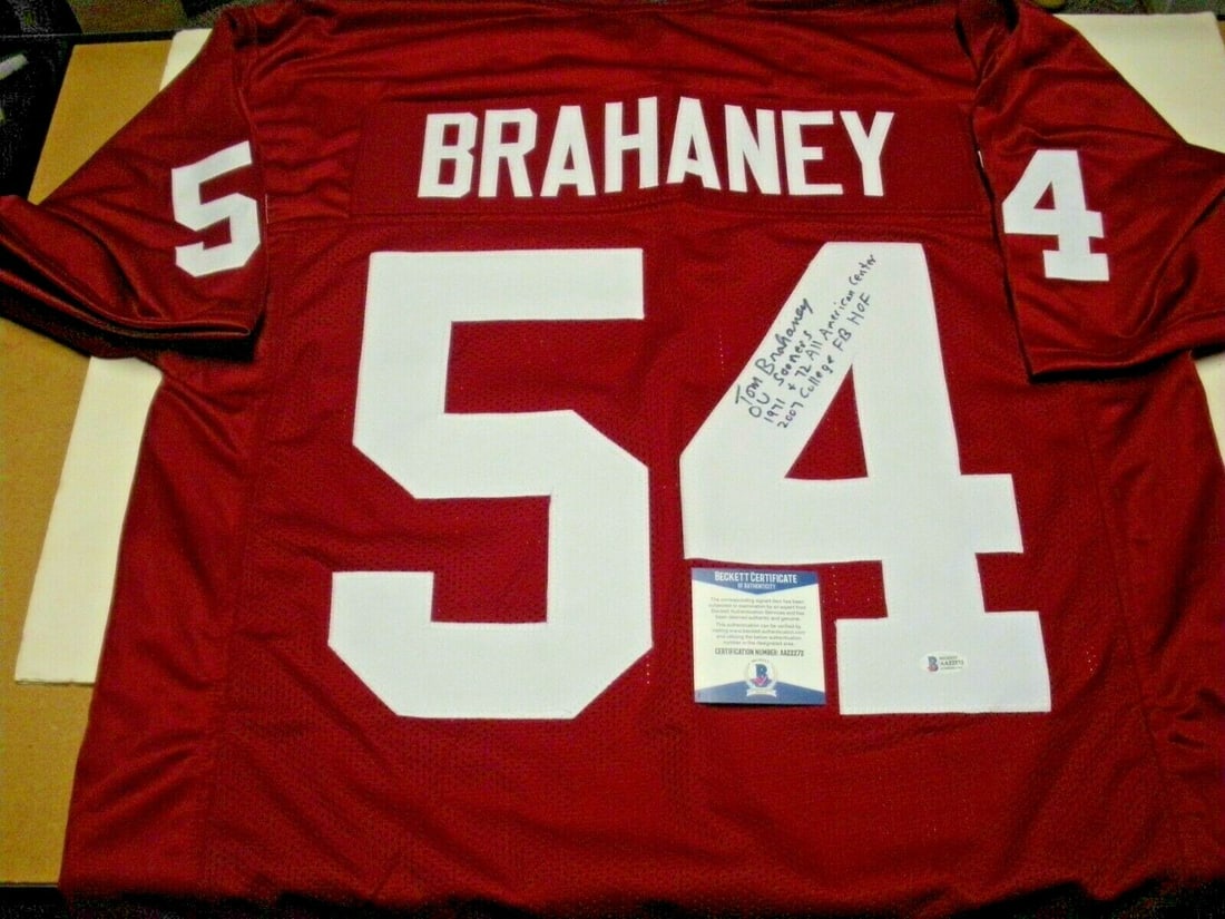 Tom Brahaney Signed Oklahoma Football Jersey With Beckett COA and CFHOF 2007: Tom Brahaney Signed Oklahoma Football Jersey With Beckett COA and CFHOF 2007 This pre-owned Oklahoma Sooners jersey is signed by Tom Brahaney, a member of the College Football Hall of Fame (CFHOF) 200