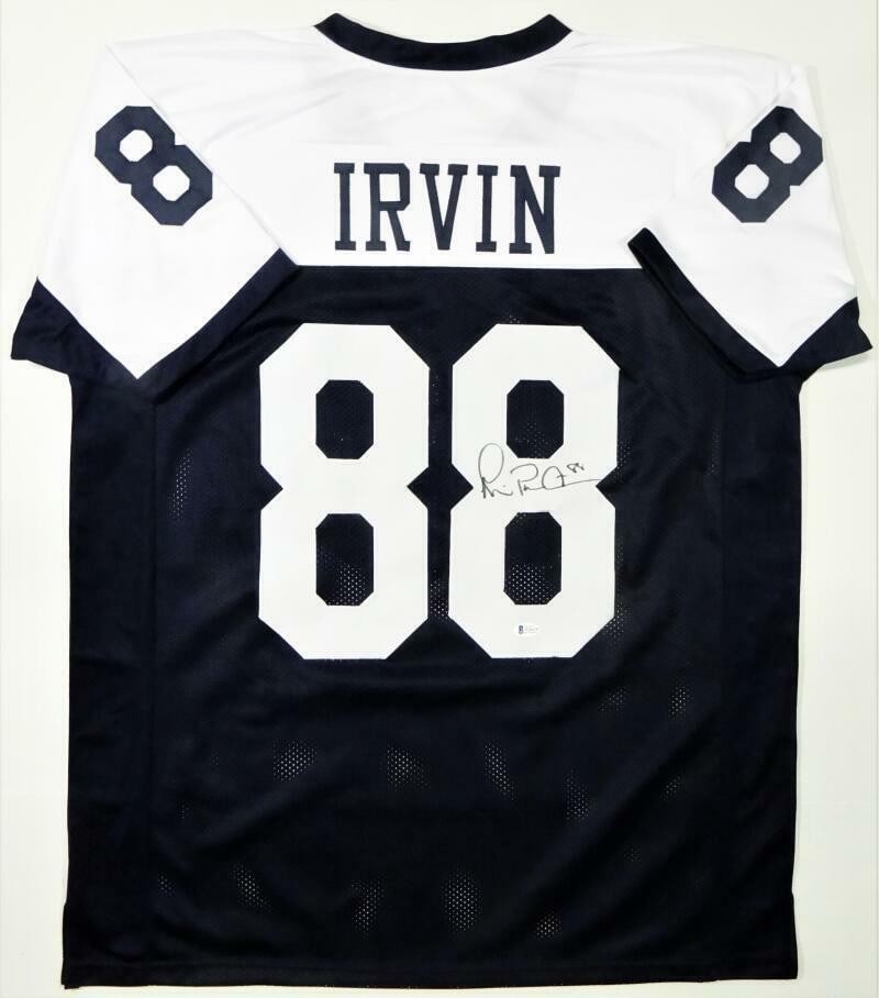 Signed Michael Irvin Pro Style White Blue Jersey Beckett Authenticated: Signed Michael Irvin Pro Style White Blue Jersey Beckett Authenticated This white and blue pro style football jersey is autographed by Michael Irvin and comes authenticated by Beckett. Representing th