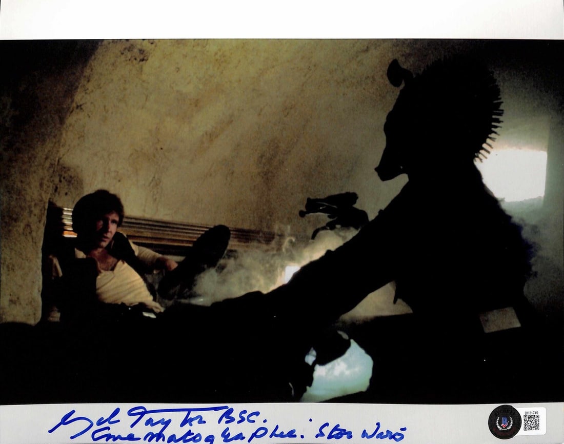 Gilbert Taylor Signed Star Wars 8x10 Photo Beckett Authenticated: Gilbert Taylor Signed Star Wars 8x10 Photo Beckett Authenticated This is an original 8x10 photograph featuring Han and Greedo, signed in blue permanent marker by Gil Taylor, the cinematographer for th