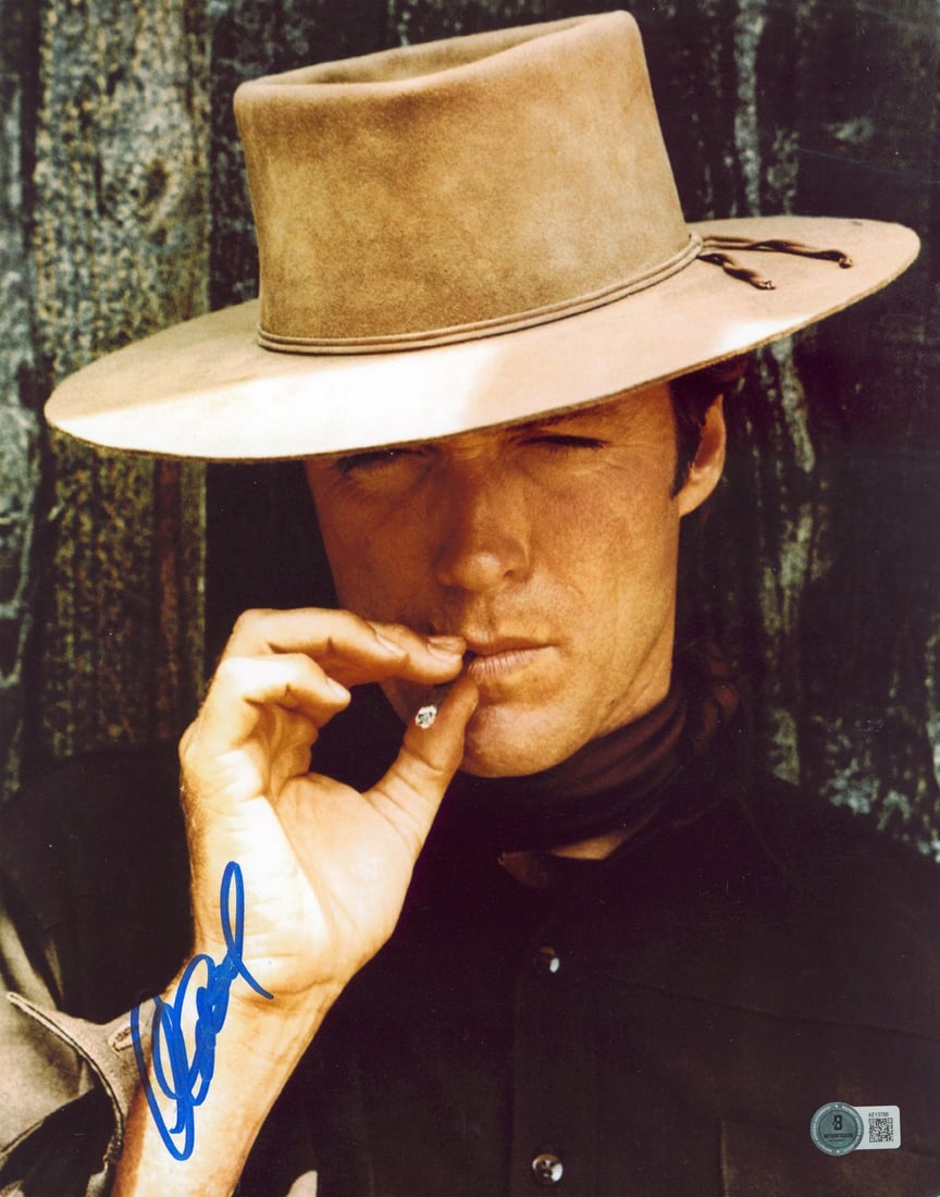 Clint Eastwood Hang 'Em High Signed 11x14 Photo Beckett COA: Clint Eastwood Hang 'Em High Signed 11x14 Photo Beckett COA This authentic signed 11x14 vertical photograph features Clint Eastwood from the classic film "Hang 'Em High." The photograph has been perso