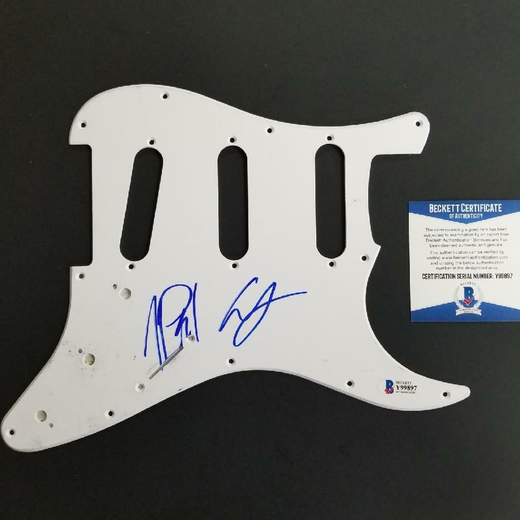Signed Pickguard by The Chainsmokers Alex Pall Andrew Taggart Beckett Authenticated: Signed Pickguard by The Chainsmokers Alex Pall Andrew Taggart Beckett Authenticated This is an original guitar pickguard signed by Alex Pall and Andrew Taggart of The Chainsmokers. The autographs are 