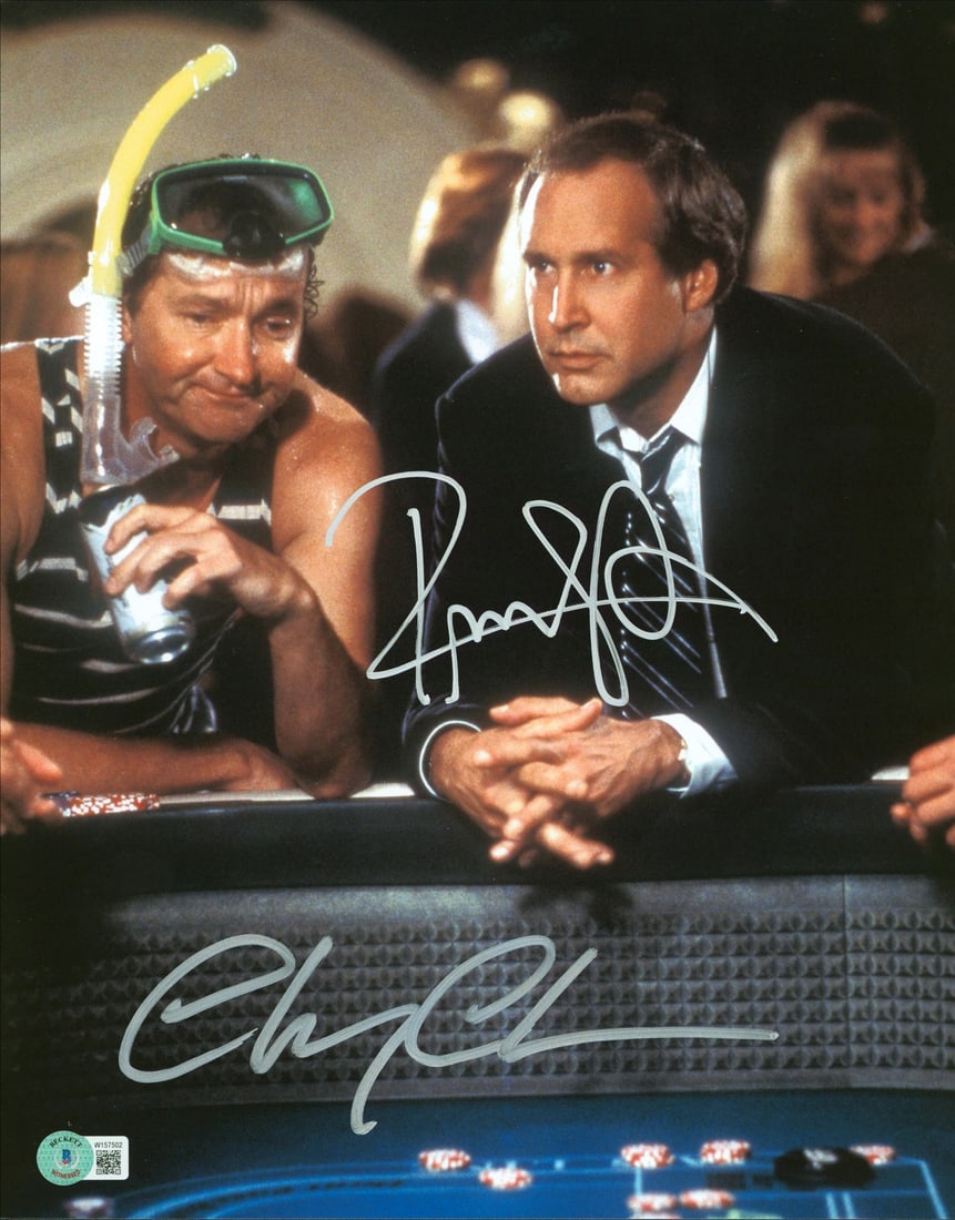 Chevy Chase Randy Quaid Signed 11x14 Vegas Vacation Photo BAS Authenticated: Chevy Chase Randy Quaid Signed 11x14 Vegas Vacation Photo BAS Authenticated Capture a moment from the classic film 'Vegas Vacation' with this autographed 11x14 photograph featuring the signatures of C