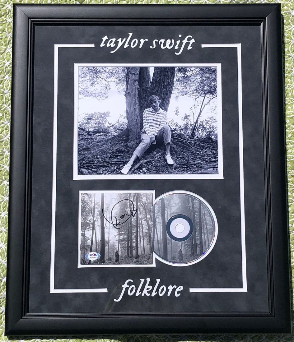 Taylor Swift Signed Folklore CD Cover PSA/DNA Grade 10 Framed 18.5x22: Taylor Swift Signed Folklore CD Cover PSA/DNA Grade 10 Framed 18.5x22 This is an original framed CD album cover of Taylor Swift's 'Folklore' featuring her authenticated signature. The autograph has be