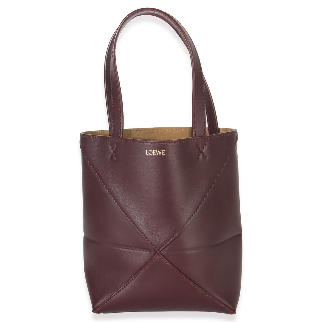 Loewe Mini Puzzle Fold Top Handle Tote in Burgundy Calfskin Leather: Loewe Mini Puzzle Fold Top Handle Tote in Burgundy Calfskin Leather This Loewe Burgundy Calfskin Mini Puzzle Fold Tote features a luxurious leather exterior in a striking red hue. Designed for unisex 