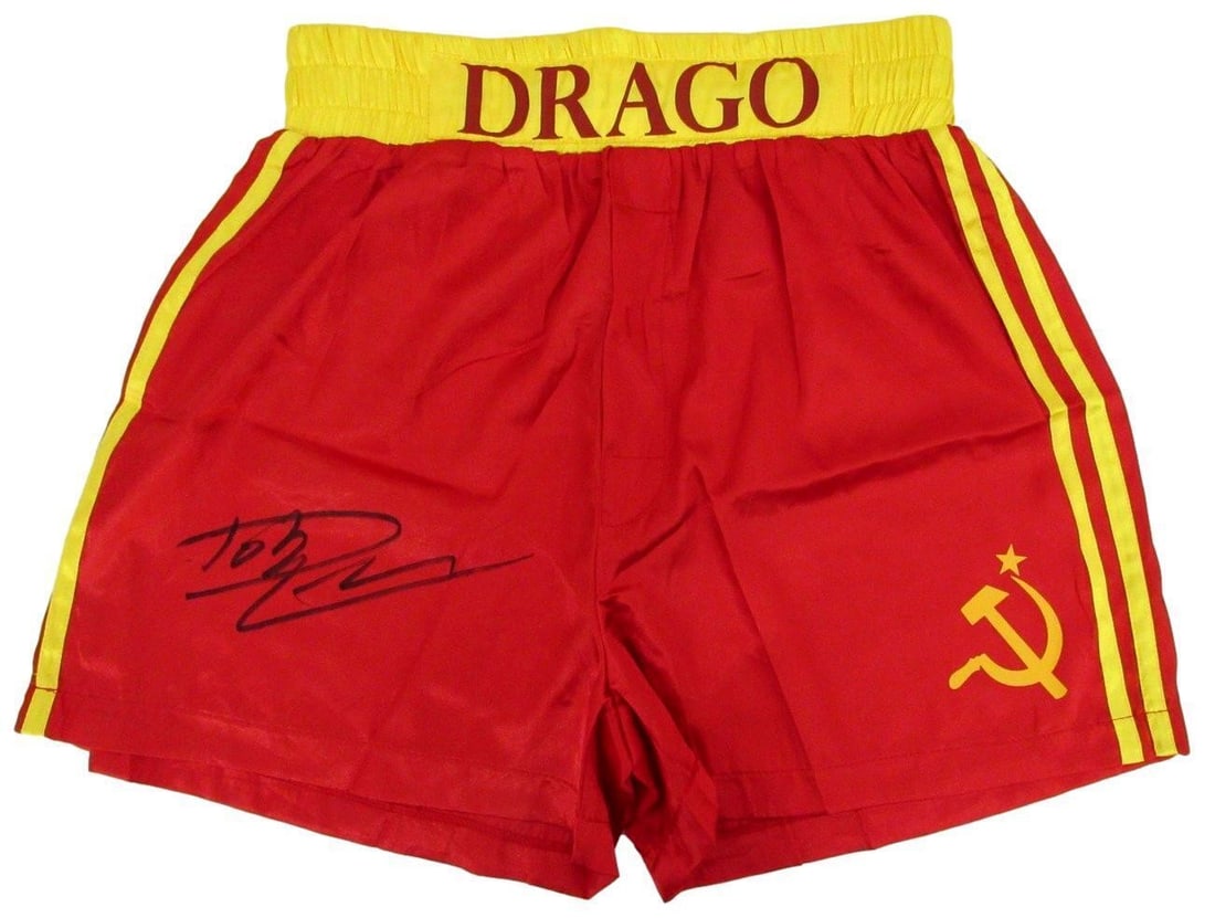 Dolph Lundgren Signed Ivan Drago Boxing Trunks PSA/DNA Certified: Dolph Lundgren Signed Ivan Drago Boxing Trunks PSA/DNA Certified This listing features a pair of red boxing trunks autographed by Dolph Lundgren, known for his iconic role as Ivan Drago in Rocky IV. T