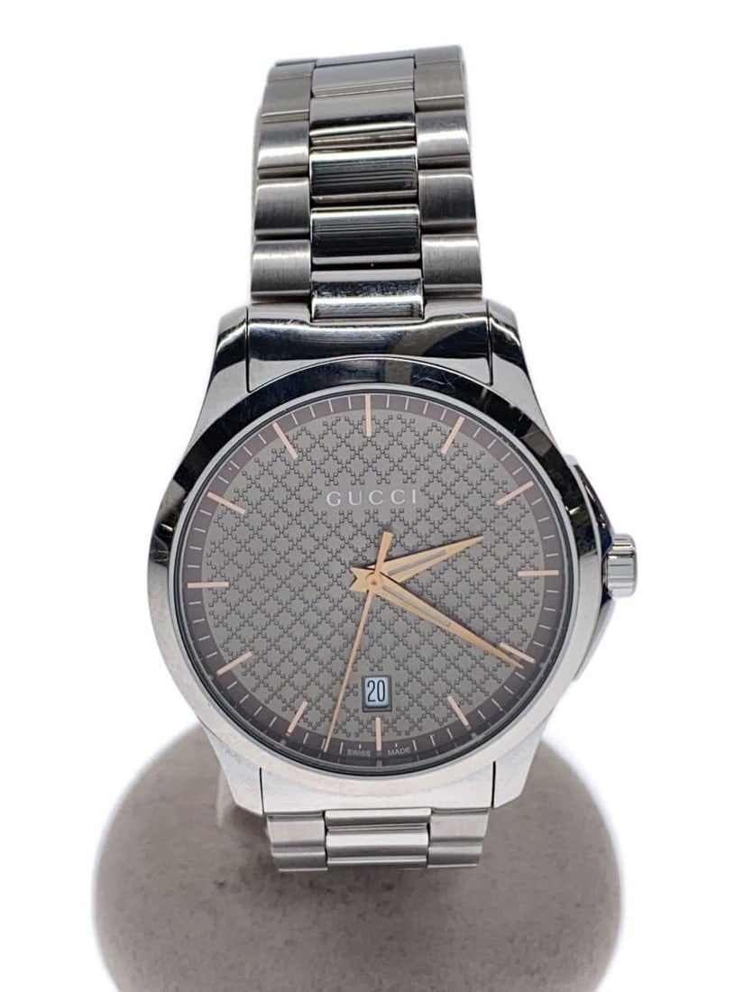 Gucci 126.4 Swiss Gold Tone Wristwatch: Gucci 126.4 Swiss Gold Tone Wristwatch This Gucci G-Timeless 126.4 men's wristwatch features a gold-tone stainless steel case and band. Crafted in Switzerland, it is designed for men and presents a cl