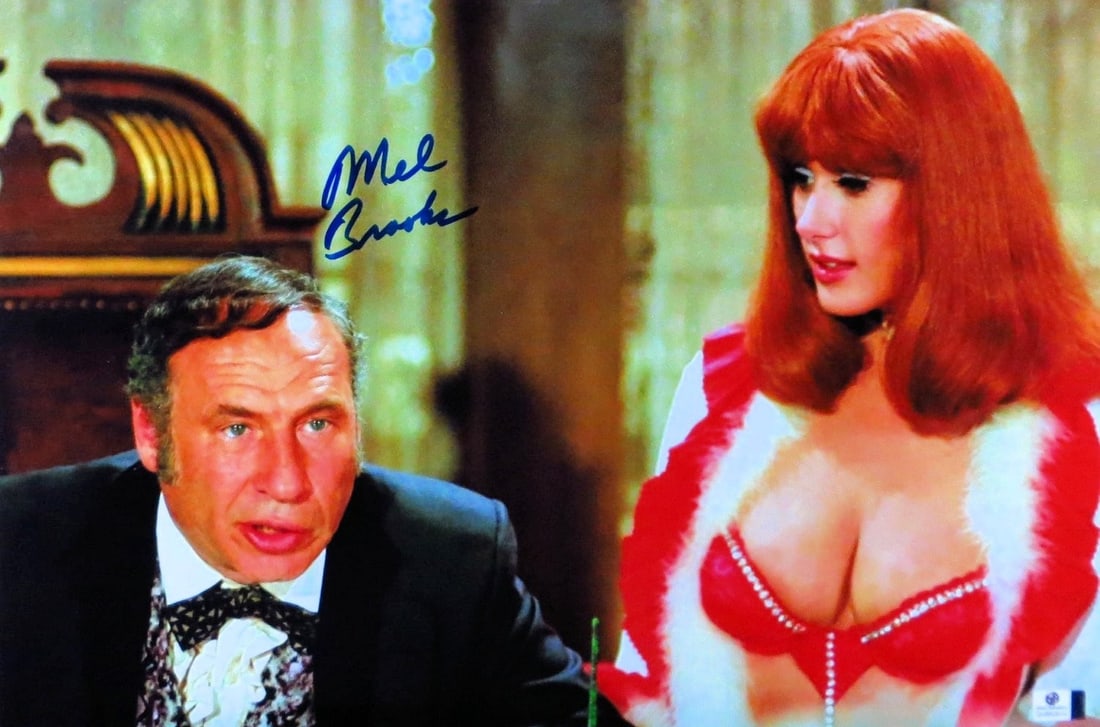 Mel Brooks Autographed 12X18 Photo Blazing Saddles JSA Certified: Mel Brooks Autographed 12X18 Photo Blazing Saddles JSA Certified This is an original 12x18 photograph of Mel Brooks, featuring his signature. The photograph is a classic moment from the iconic film "B