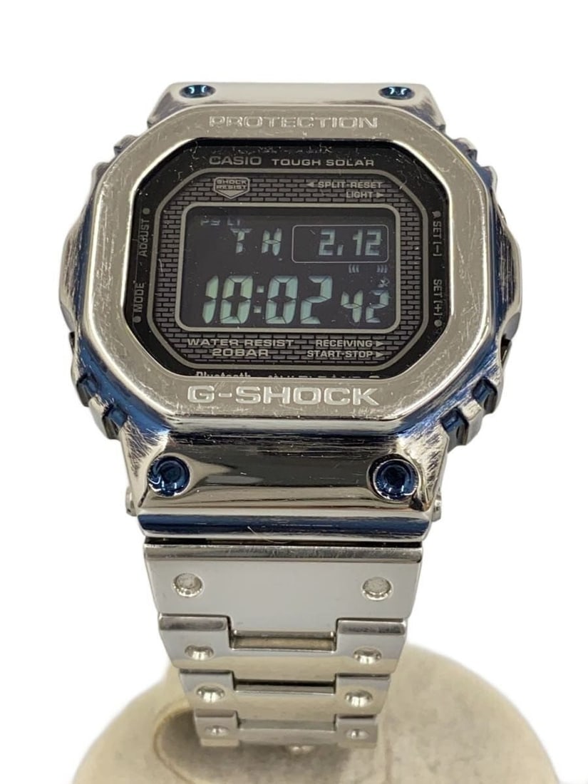 Casio G-Shock GMW-B5000D-1JF Silver Men's Wristwatch: Casio G-Shock GMW-B5000D-1JF Silver Men's Wristwatch This CASIO G-SHOCK GMW-B5000D-1JF men's wristwatch features a durable silver-tone design with a robust build. The pre-owned watch is in Grade B con