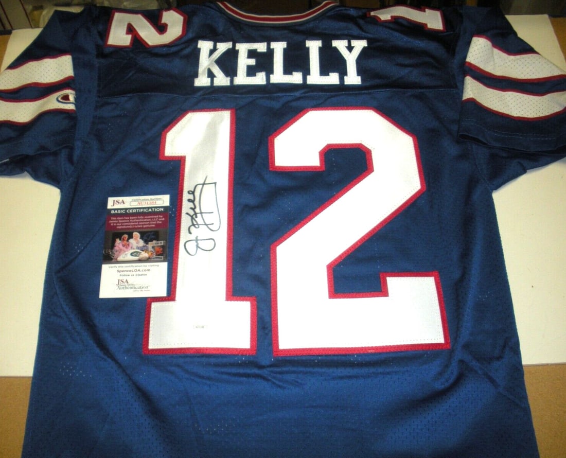 Champion Buffalo Bills Jersey Signed by Jim Kelly with JSA Authentication: Champion Buffalo Bills Jersey Signed by Jim Kelly with JSA Authentication This is an officially licensed Champion jersey signed by Jim Kelly of the Buffalo Bills. The jersey includes authentication wi