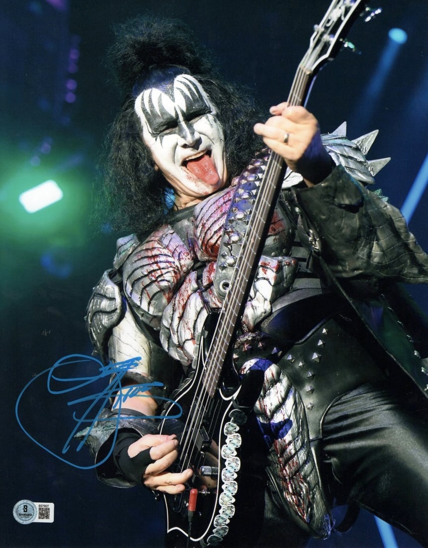 Gene Simmons Autographed 11x14 KISS Photo Beckett Authenticated: Gene Simmons Autographed 11x14 KISS Photo Beckett Authenticated Capture a piece of rock history with this Gene Simmons autographed 11X14 photograph showcasing the legendary KISS performing on stage. T