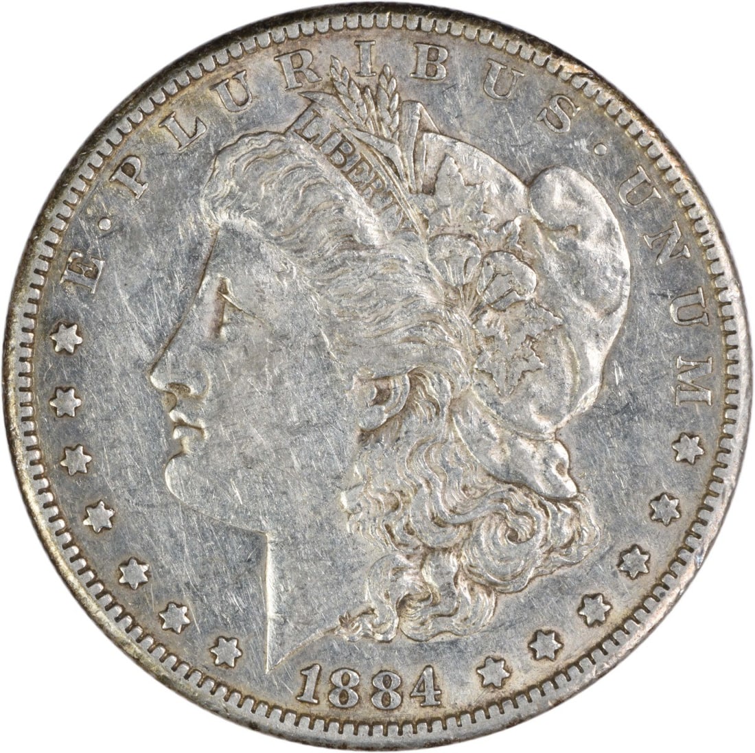 AU Grade 1884 Carson City Morgan Dollar Uncertified Silver Coin: AU Grade 1884 Carson City Morgan Dollar Uncertified Silver Coin This 1884-CC Morgan Silver Dollar is an attractive pre-owned coin struck at the Carson City Mint. Composed of 90% silver and 10% copper,